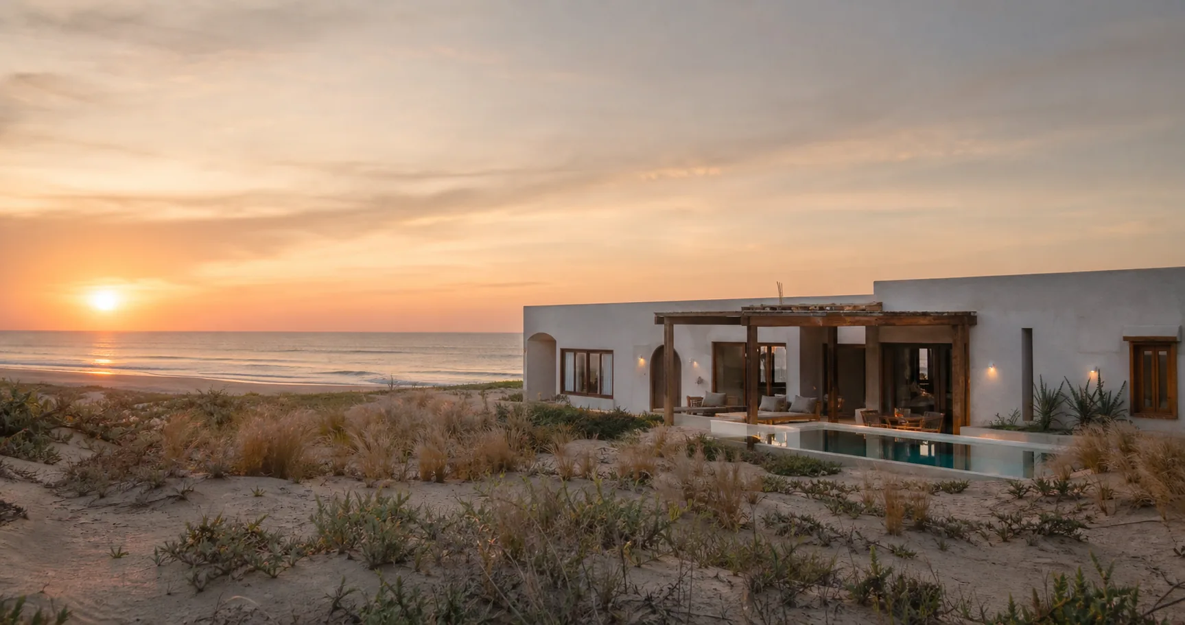 Casa litorânea fictícia diante do mar ao nascer do sol